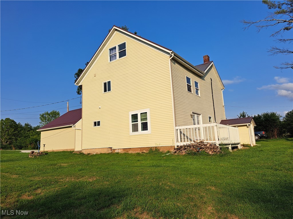 49197 John Tomcho Road Cumberland, OH 43732 - Photo 5 of 50 Back of house featuring a yard