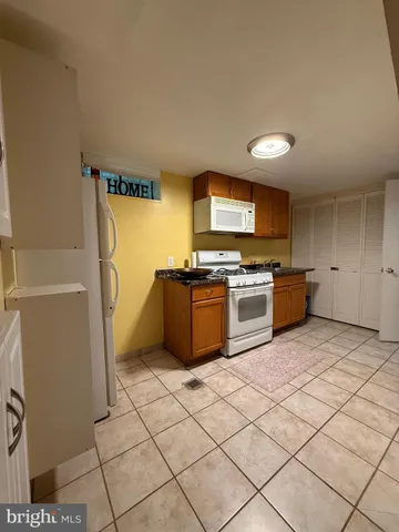 a kitchen with a cabinets and a stove top oven