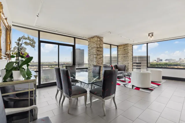 a living room with furniture and a floor to ceiling window