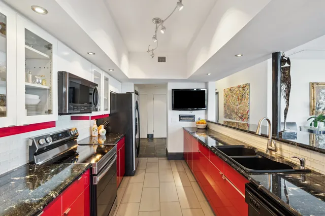 a kitchen that has a lot of appliances and cabinets
