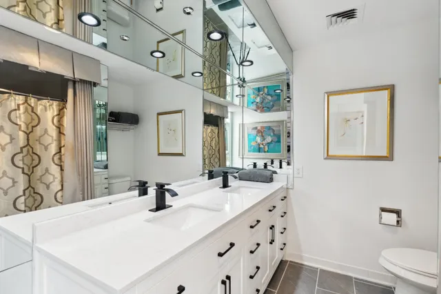 a bathroom with a sink double vanity and a mirror