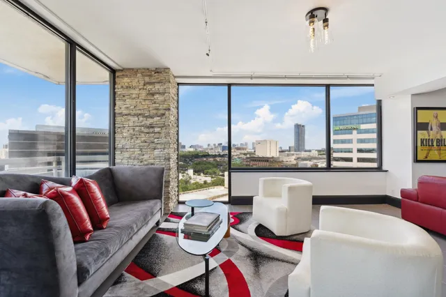 a living room with furniture and a large window