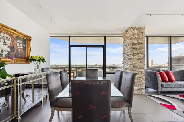 a living room with furniture and a floor to ceiling window