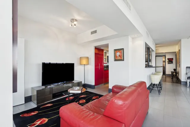 a bedroom with bed and a flat screen tv