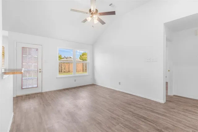 a kitchen with granite countertop a sink cabinets and stainless steel appliances
