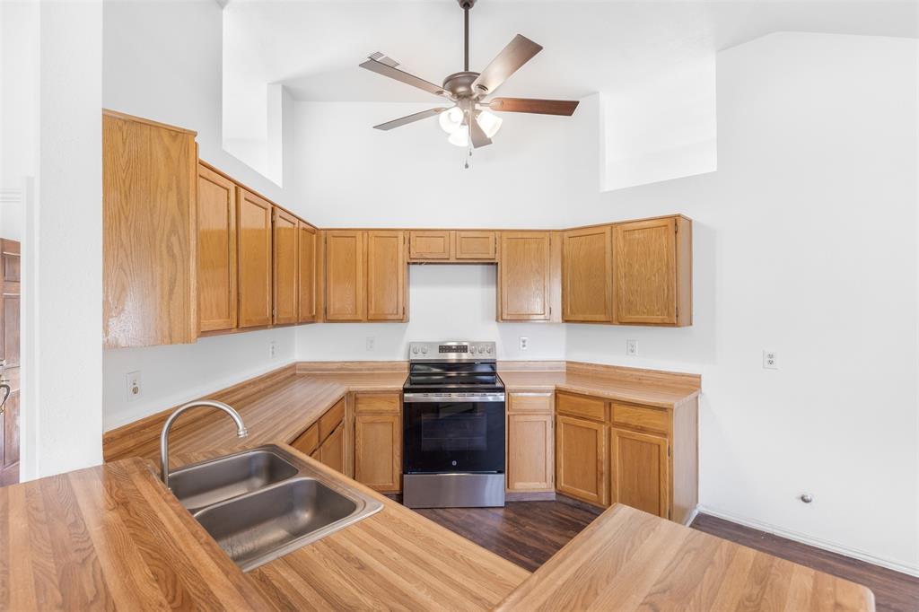1313 Clover Drive Allen, TX 75002 - Photo 16 of 30 a kitchen with a stove and a sink