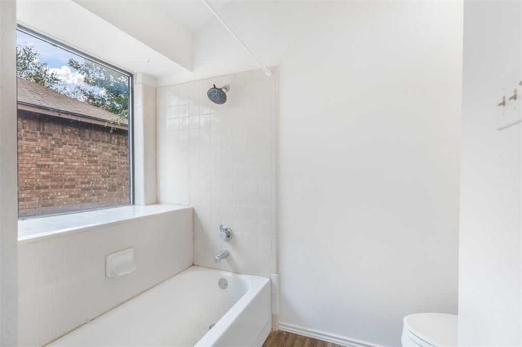 1313 Clover Drive Allen, TX 75002 - Photo 17 of 30 a bathroom with a bathtub and toilet