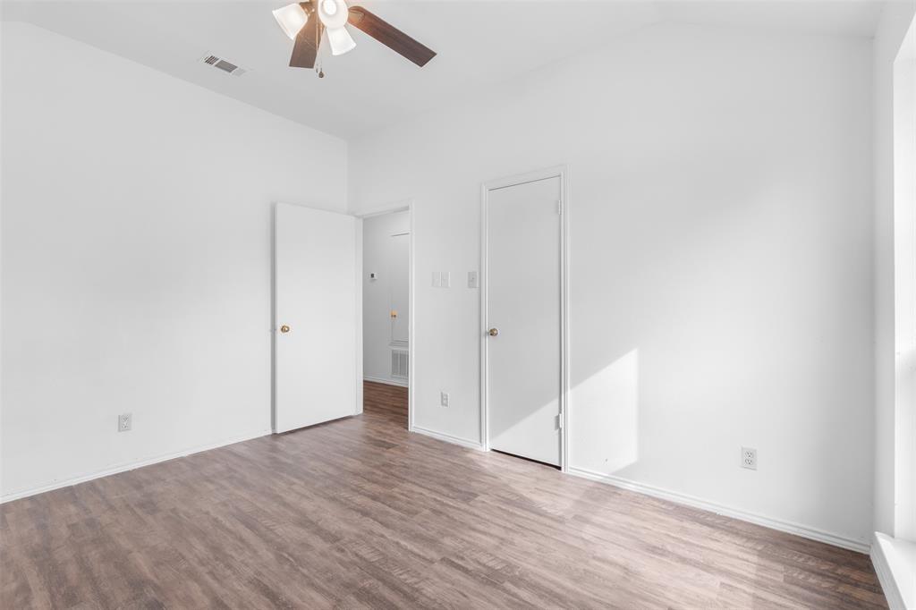 1313 Clover Drive Allen, TX 75002 - Photo 20 of 30 an empty room with a ceiling fan and wooden floor