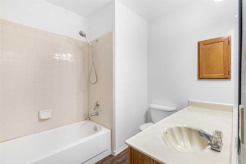 1313 Clover Drive Allen, TX 75002 - Photo 21 of 30 a bathroom with a tub a sink and toilet
