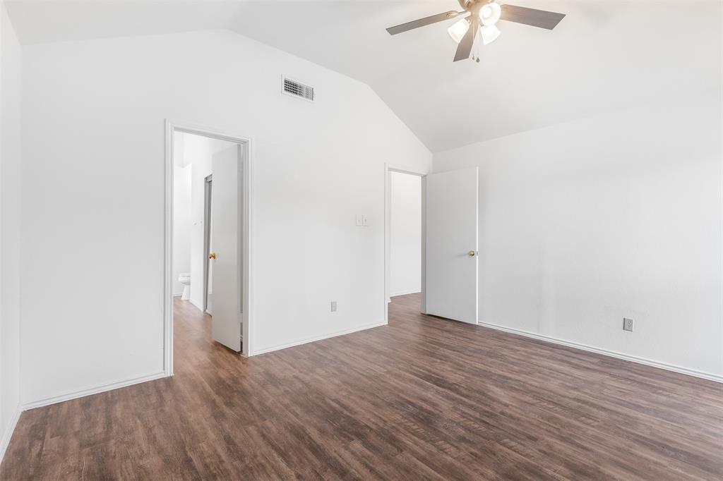 1313 Clover Drive Allen, TX 75002 - Photo 25 of 30 an empty room with wooden floor fan and windows