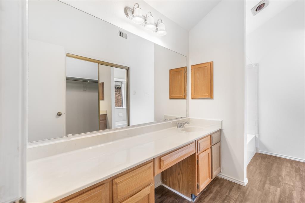 1313 Clover Drive Allen, TX 75002 - Photo 26 of 30 a bathroom with a sink and a mirror