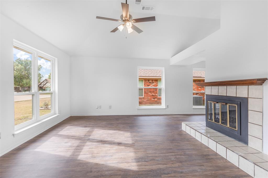 1313 Clover Drive Allen, TX 75002 - Photo 6 of 30 a view of an empty room with a fireplace and a window
