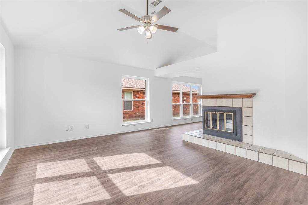 1313 Clover Drive Allen, TX 75002 - Photo 7 of 30 a view of an empty room with a fireplace and a window