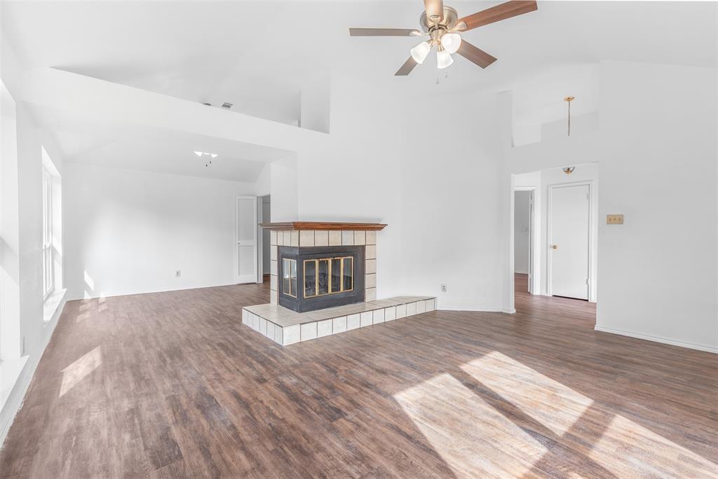 1313 Clover Drive Allen, TX 75002 - Photo 8 of 30 a view of empty room with wooden floor and fan