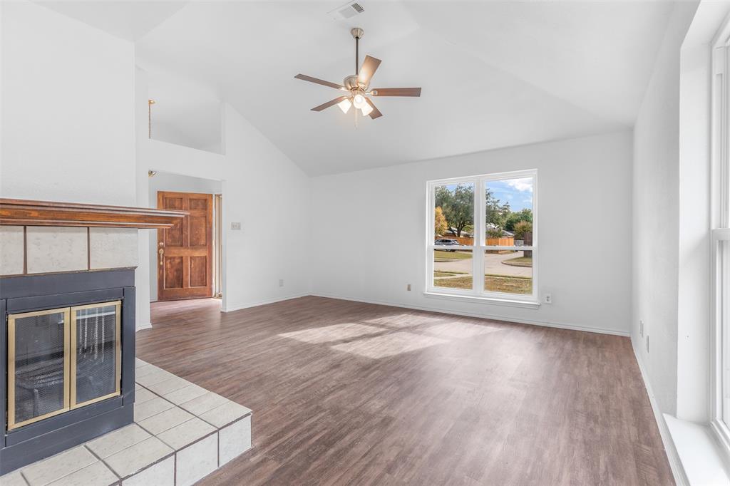 1313 Clover Drive Allen, TX 75002 - Photo 9 of 30 a view of an empty room with wooden floor and a window