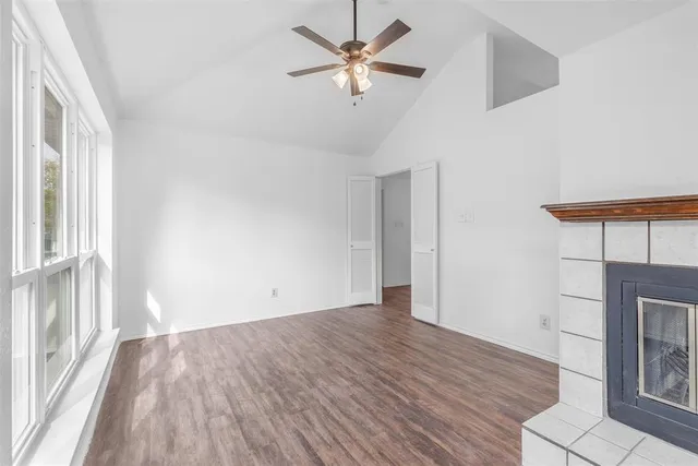 a view of a kitchen with wooden floor and a ceiling fan