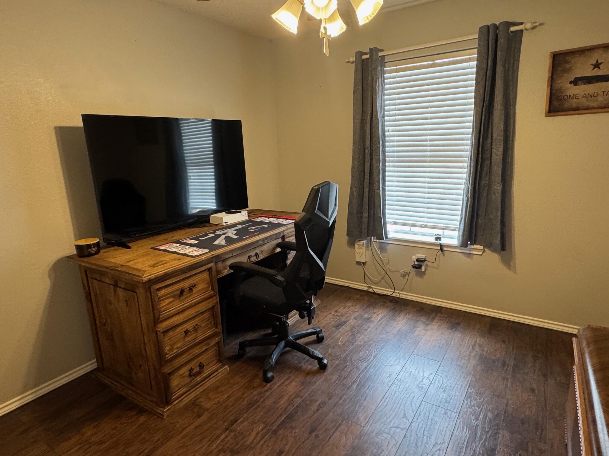 1906 81st Street Lubbock, TX 79423 - Photo 11 of 14 a view of workspace with wooden floor windows