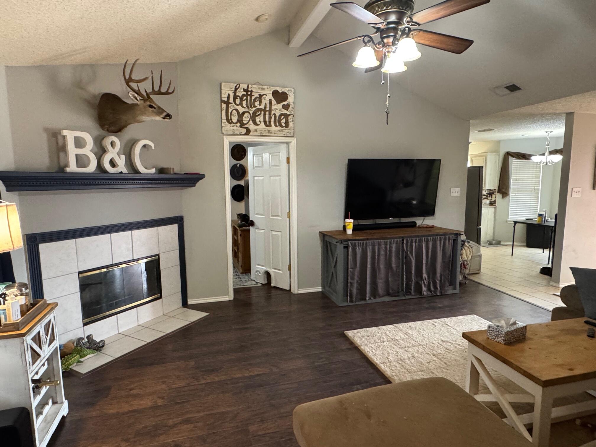 1906 81st Street Lubbock, TX 79423 - Photo 4 of 14 a living room with furniture and a flat screen tv