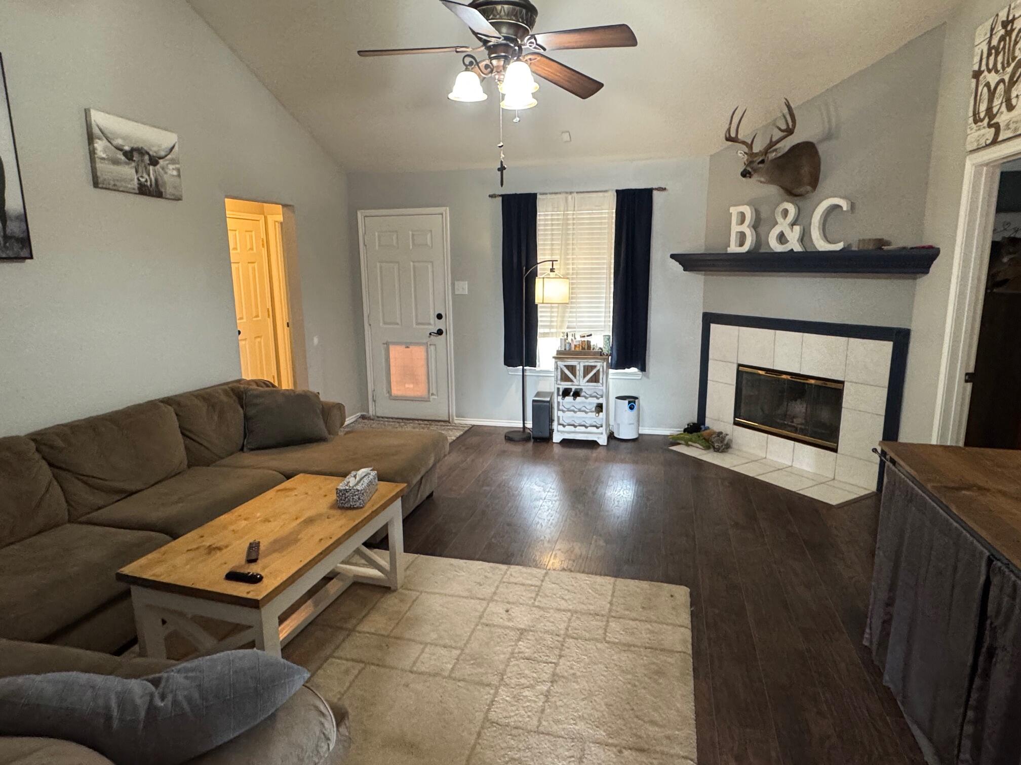 1906 81st Street Lubbock, TX 79423 - Photo 5 of 14 a living room with furniture and a fireplace
