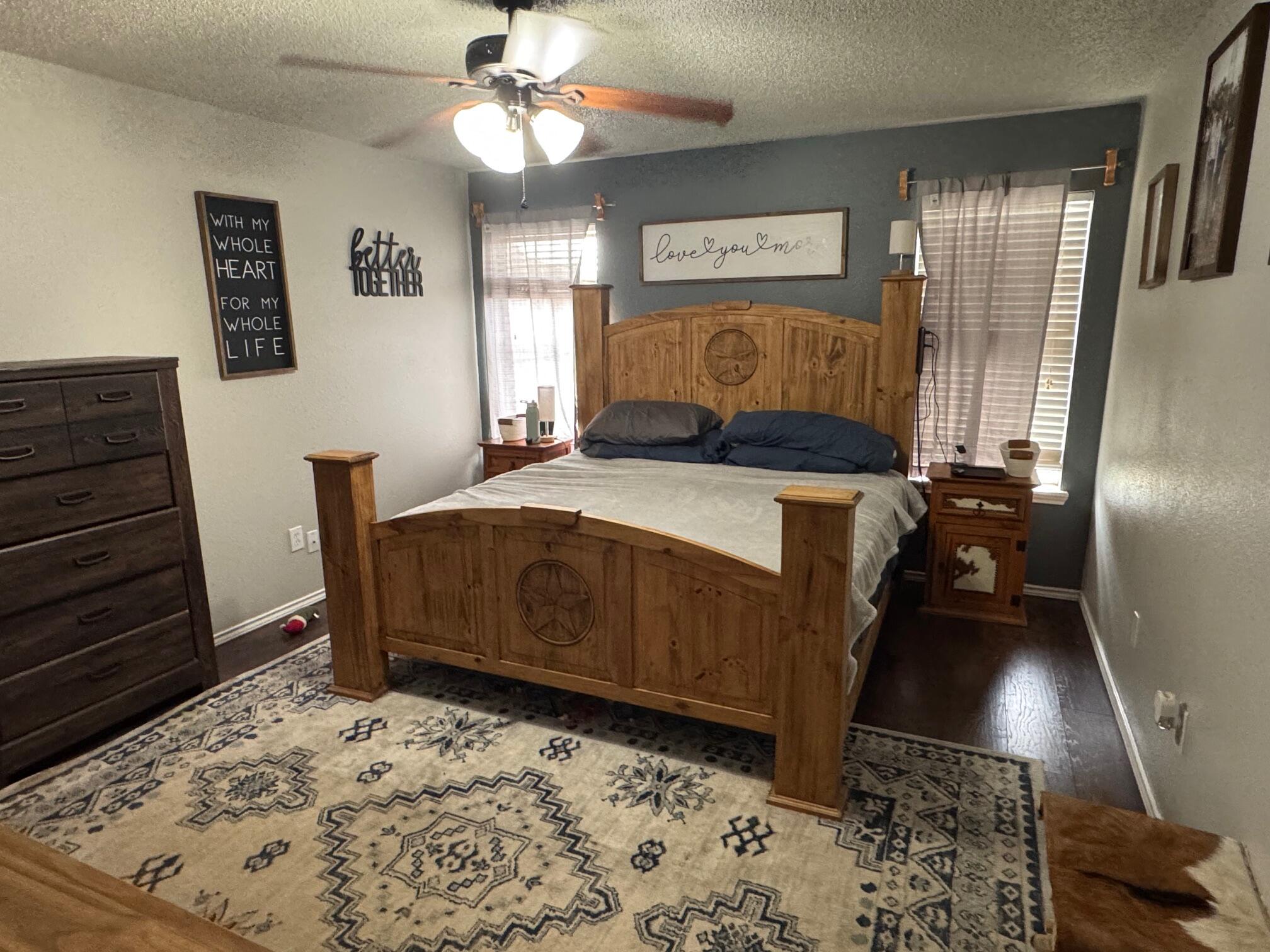 1906 81st Street Lubbock, TX 79423 - Photo 7 of 14 a bedroom with a bed and a mirror on the dresser