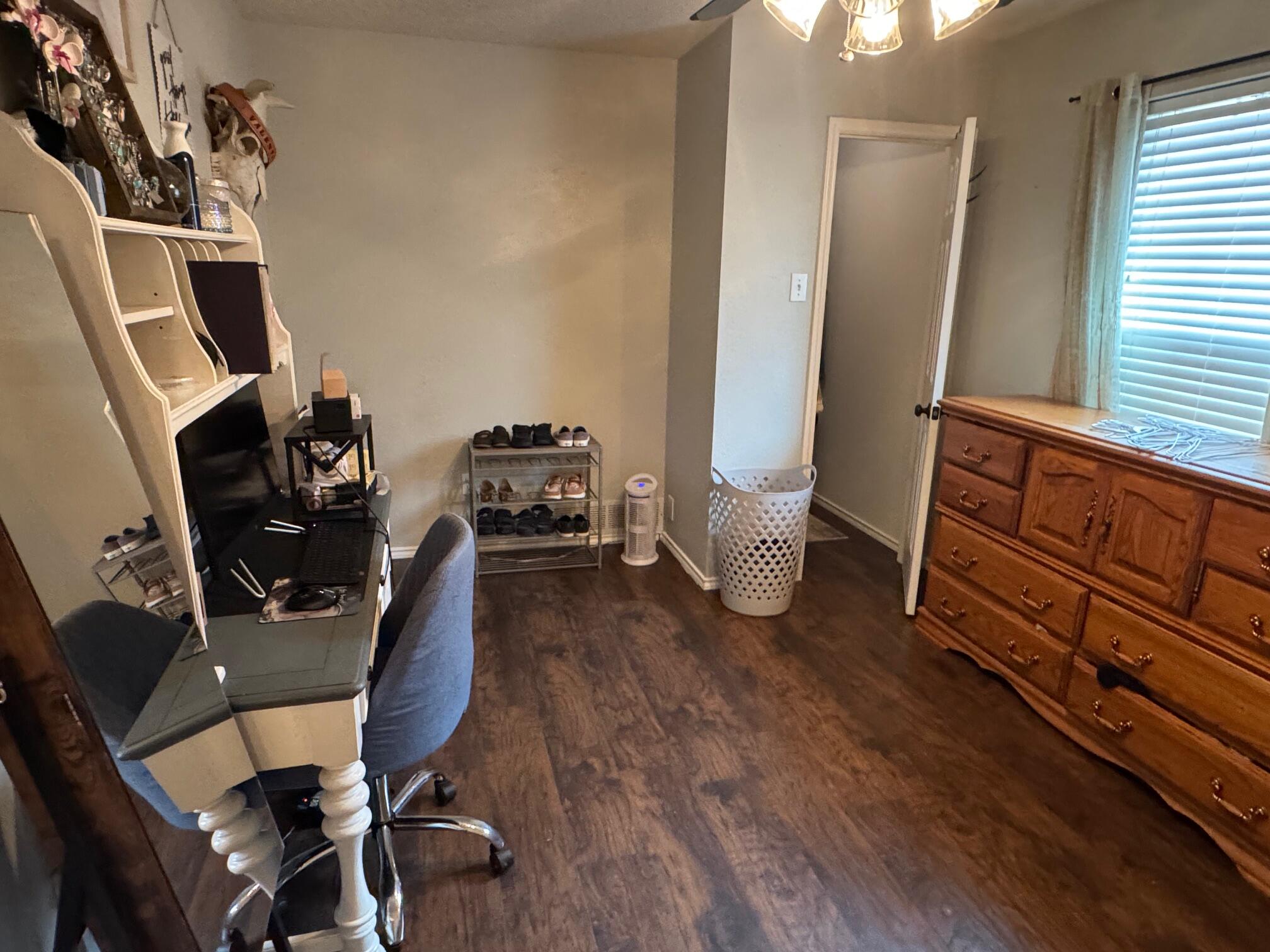 1906 81st Street Lubbock, TX 79423 - Photo 10 of 14 a view of a workspace with furniture and a window