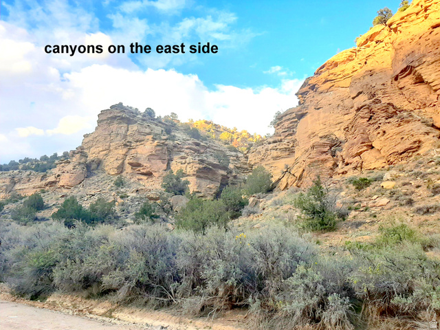 3366 Thompson Cyn Road, Unit B Green River, UT 84525 - Photo 2 of 17 Natural canyon formations featuring stratified rock faces, rugged terrain, and scattered desert vegetation