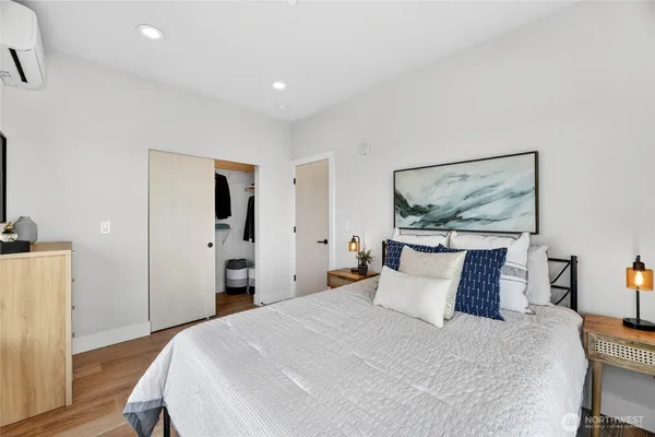 a bedroom with a bed and a painting on the wall