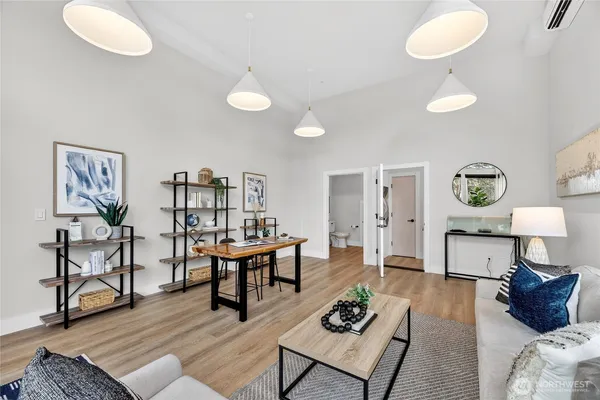 a living room with furniture and a wooden floor
