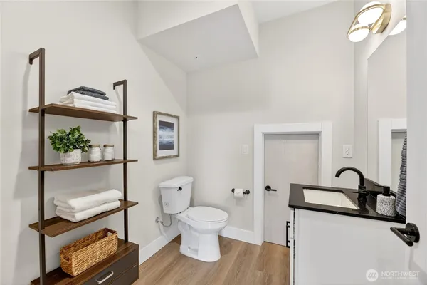 a bathroom with a toilet a sink and a window