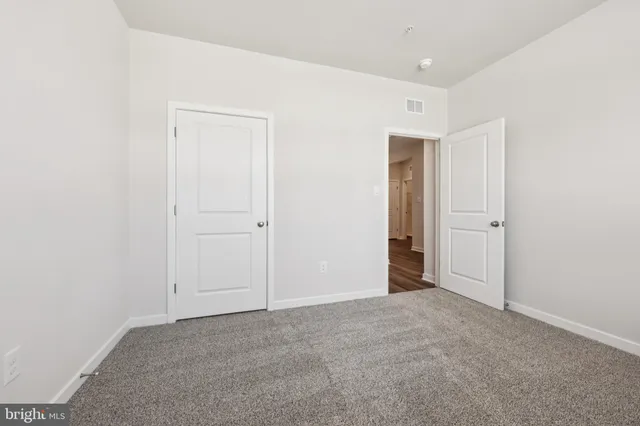 an empty room with closet area