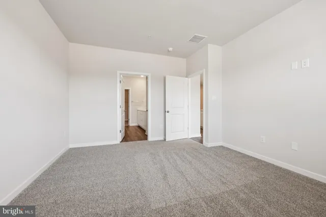 a view of a big room with closet and window