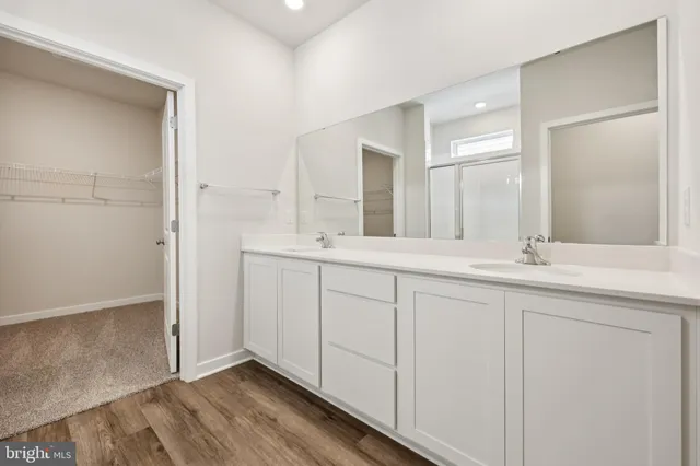 a bathroom with a double vanity sink and mirror