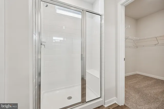 a bathroom with a glass shower door