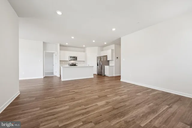 a view of a kitchen with a sink and a refrigerator
