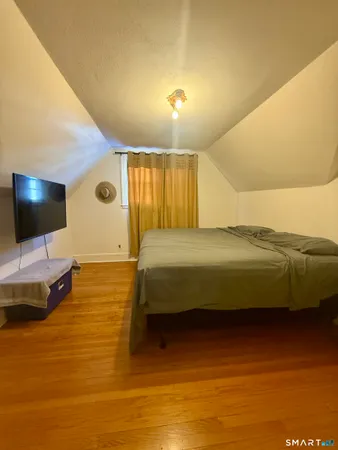 a bedroom with a bed and a flat screen tv