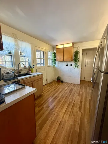 a kitchen with stainless steel appliances kitchen island granite countertop a refrigerator and a stove