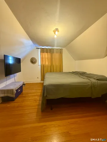 a bedroom with a bed a flat screen tv and cabinets