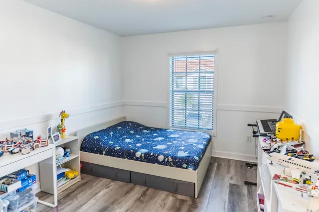 a room with toys and kitchen view