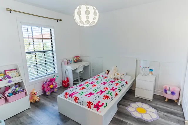 a bedroom with toys and a window