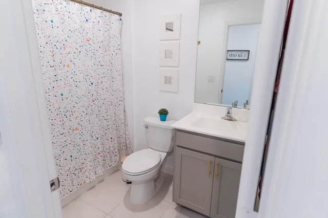 a white toilet sitting next to a bathroom sink