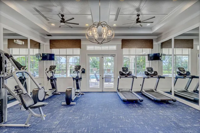 a living room with furniture a window and gym equipment