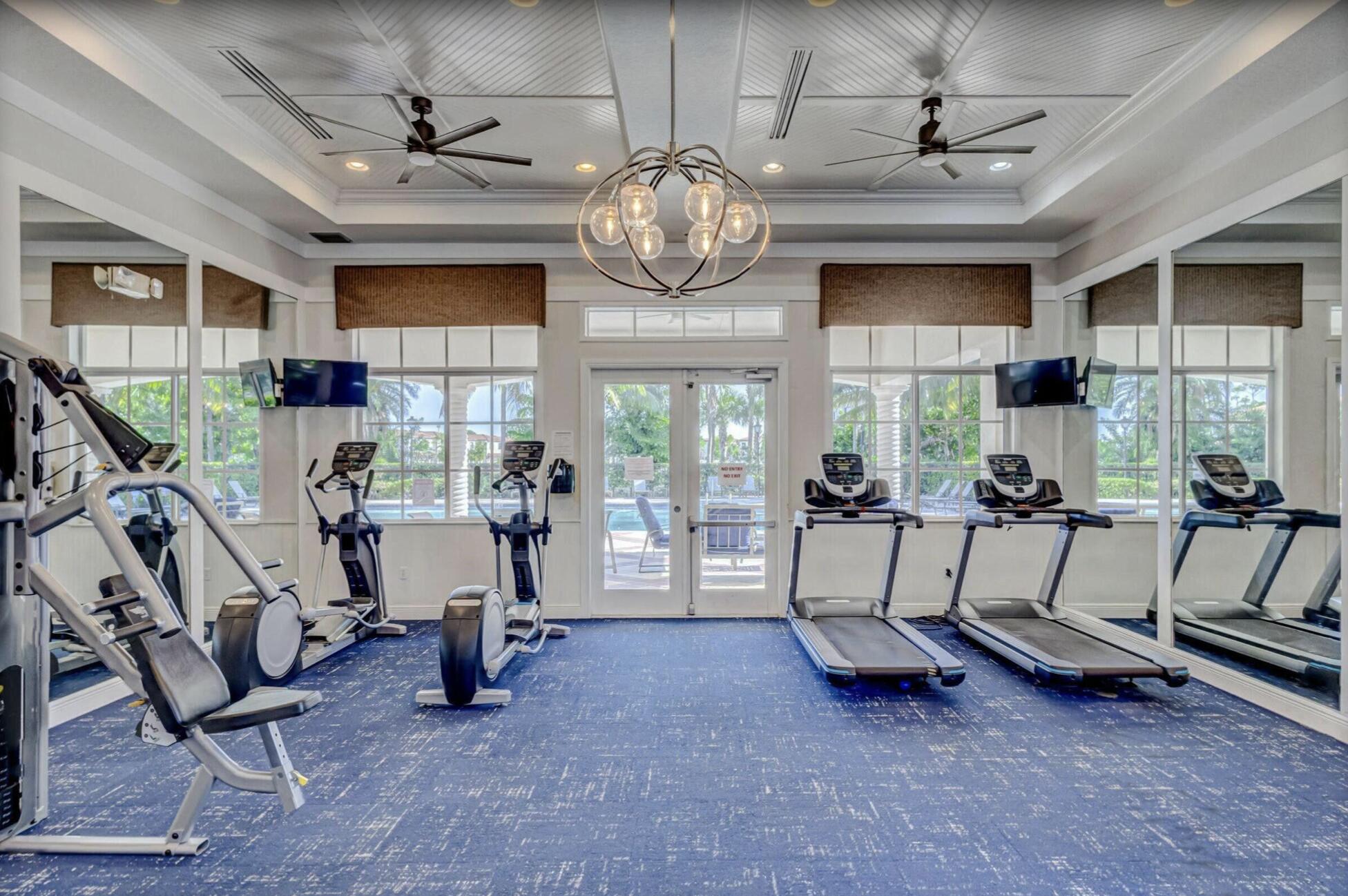 2025 Sugar Maple Drive Riviera Beach, FL 33410 - Photo 22 of 23 a living room with furniture a window and gym equipment
