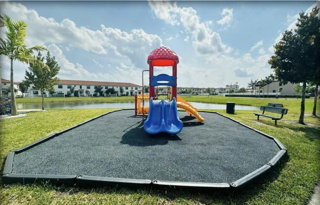 a view of a lake with a swimming pool and a garden