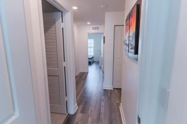 a view of hallway with wooden floor