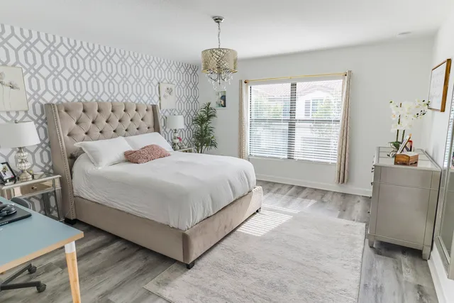 a bedroom with a large bed and a window