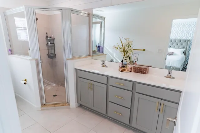 a bathroom with a double vanity sink and mirror