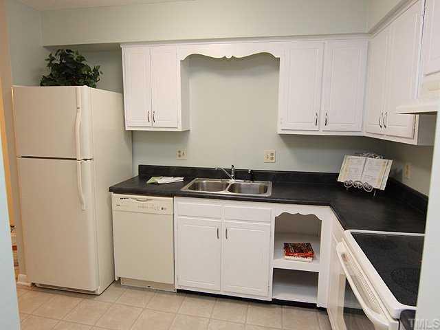 552 Pine Ridge Place Raleigh, NC 27609 - Photo 4 of 12 Newly painted cabinets with new hardware, new vinyl flooring, new stainless sink, new appliances, new painted walls, and new countertops make this a really nice kitchen to use and to just look at.