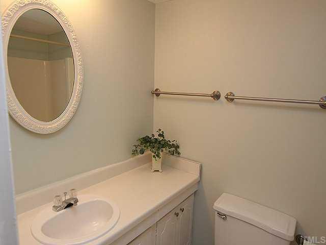 552 Pine Ridge Place Raleigh, NC 27609 - Photo 7 of 12 Master bathroom showing new sink. Cabinets newly painted and new hardware. Walls painted. New towel racks. New vinyl floor.