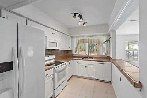 a kitchen that has a sink and a stove