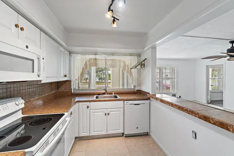 a kitchen with a sink stove and cabinets